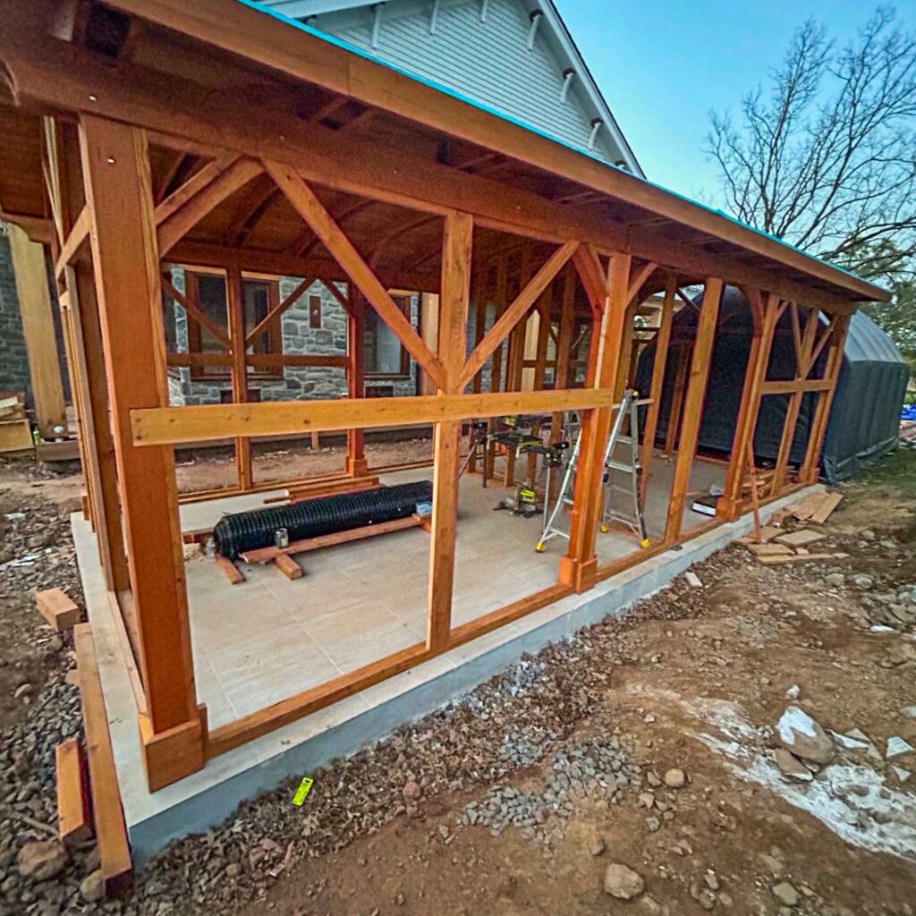 Large wooden catio under construction on a concrete foundation
