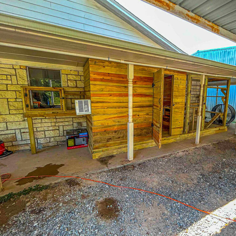 Outdoor custom catio structure attached to a home with wood paneling and screened sections.