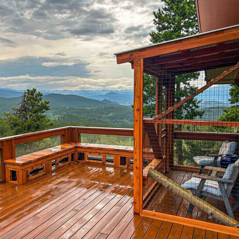 Wooden catio beside mountain deck overlooking forest