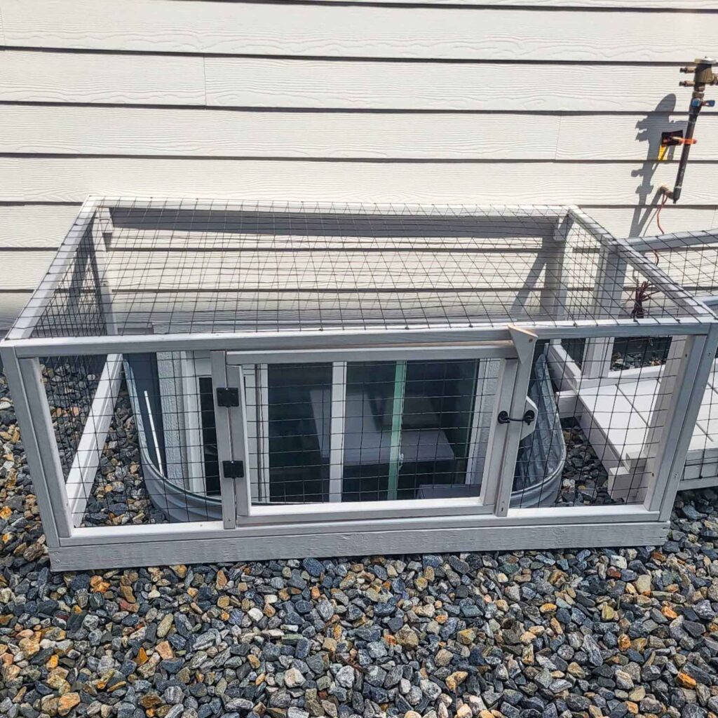 Small outdoor catio with window access enclosure