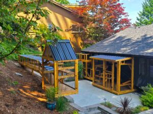Multi-structure custom catio system with enclosed walkways connecting several wooden enclosures.